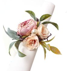 a close up of a napkin with flowers on it and greenery around the edge