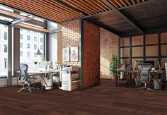 an office with brick walls and wooden floors