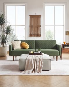 a living room scene with focus on the couch and coffee table in the foreground