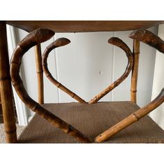 a chair made out of bamboo sticks with heart shaped handles