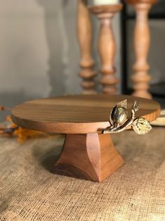 a close up of a wooden cake plate on a table