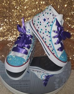 Custom bling Turquoise, Purple and Pearl Converse is the perfect shoes for any occasion, each pair can be personalized to your liking. * All Converse shoes are 100% authentic from Converse or authorized retail sellers. Shoes are not returnable once they are customized. So please make sure you order the correct size. * Shoes can be made with different color stones, pearls and different size if requested. * Allow two weeks for shoes to be shipped after purchase date. (shoes are normally done withi Bedazzled Shoes Diy Rhinestone Converse, Converse Blinged Out, Pink And Green Bling Converse, Custom Purple High-top Sneakers With Cushioned Footbed, Purple Bedazzled Converse, Pearl Converse, Bedazzled Converse, Purple Converse, Bedazzled Shoes Diy