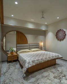 a large bed sitting in the middle of a bedroom next to a mirror and lamp