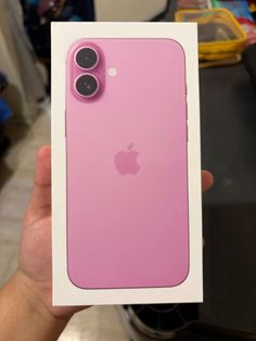 a person holding up a pink iphone case