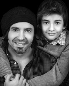 black and white photograph of a young man holding his arm around an older man's shoulder