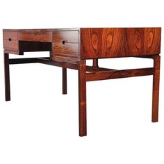 a wooden desk with two drawers on one side and an open drawer on the other