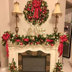 a fireplace decorated for christmas with red and gold decorations