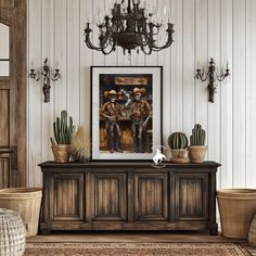 a living room filled with furniture and a painting on top of a wooden cabinet next to a chandelier