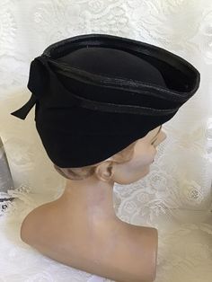 "Vintage 1940's Black Tilt Art Deco style hat. Has no makers label or tag. Only a Union Label. Plain but stylish. *SCROLL DOWN FOR CONDITION & MEASUREMENTS* CONDITION: No issues noted. MEASURES: Inside circumference~22\" Height at highest (Which is the back of the hat)~5\" Front to back~8\" Left to right~7\" **WE APOLOGIZE~BUT WE NO LONGER SHIP TO GERMANY, ITALY OR SPAIN. IF ORDERS COME IN FROM GERMANY, ITALY OR SPAIN, WE WILL HAVE TO CANCEL THEM AND REFUND YOUR MONEY. SORRY FOR THIS INCONVENIENCE**" Vintage Fitted Cloche Hat For Party, Vintage Wide Brim Costume Hats For Vintage Events, Vintage Cloche Hat With Short Brim For Parties, Fitted Cloche Costume Hats For Vintage Events, Vintage Wide Brim Costume Hat For Church, Fitted Vintage Costume Hats And Headpieces For Party, Vintage Short Brim Top Hat For Evening, Vintage Wide Brim Top Hat For Evening, Classic Fitted Mini Hats For Evening