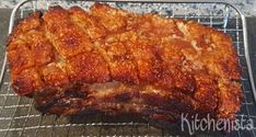 a large piece of meat sitting on top of a metal rack