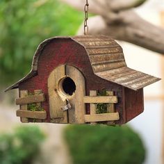 a bird house hanging from a tree branch