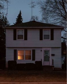 a white house with two windows at night