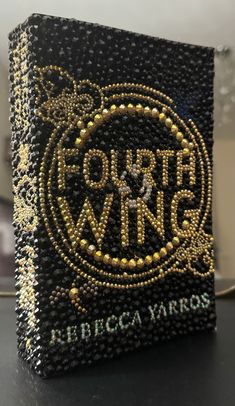 a black and gold beaded book with the words forto winery on it's cover