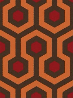 an orange and brown carpet with hexagonal shapes