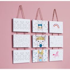 four bags hanging on the wall with pictures of animals and unicorns painted on them