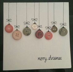 a christmas card with buttons hanging from strings