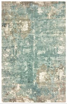 an area rug with various colors and patterns on it, including blue, green, beige and