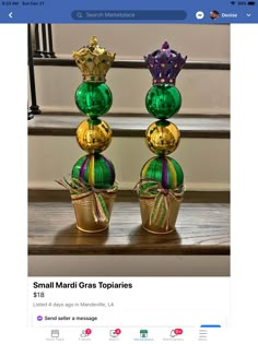 two green and gold vases sitting on top of each other in front of stairs