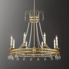 a gold chandelier with clear crystal drops hanging from it's center chain