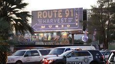 several police cars are parked in front of a route 91 harvest street sign and palm trees