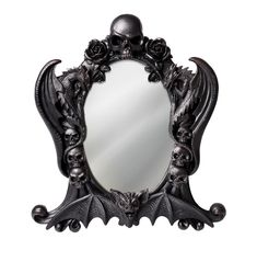 a mirror with skulls and roses on the front is decorated in gothic style metal, as well as a skull head