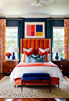 a bedroom with orange, blue and white decor