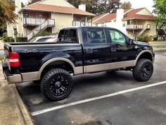 a black pickup truck parked in a parking lot