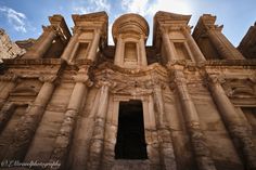 an ancient building with columns and windows