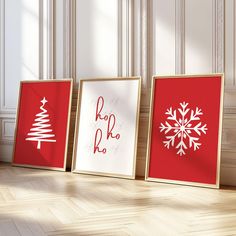 three framed christmas cards sitting on top of a wooden floor