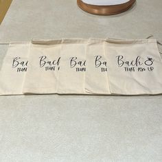 three bags with names on them sitting on a table