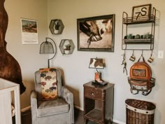 a baby's room with two chairs and pictures on the wall