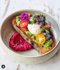 a white bowl filled with food on top of a table