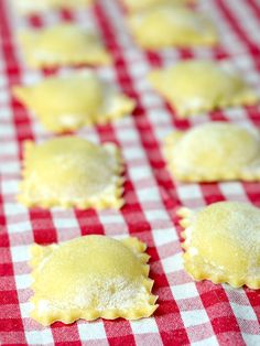 small ravioli on a red and white checkered tablecloth with holes in the middle