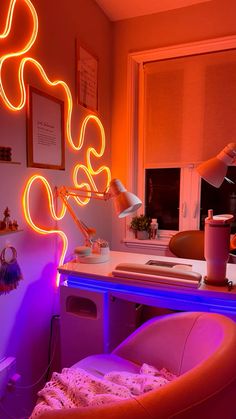 a desk with a chair and neon lights in the corner, next to a window