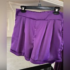 Glam Purple Satin Shorts With Sewn Cuff. Flat Front, Elastic Back Waist. Side Zipper Closure. Satin Shorts Outfit, Purple Party Shorts, Cheap Purple Bottoms With Built-in Shorts, Purple Beach Bottoms With Built-in Shorts, Purple Bottoms With Built-in Shorts And Short Inseam, Purple Summer Bottoms With Built-in Shorts, Satin Shorts, Purple Satin, Cuffed Shorts