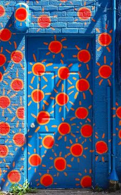 a blue door with red and orange circles painted on it