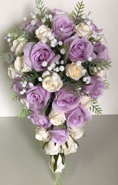 a bouquet of purple and white flowers on a table