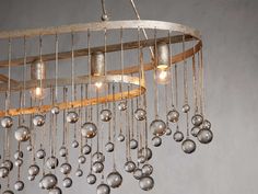 a chandelier made out of metal balls hanging from the ceiling