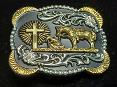 This belt buckle has a lot going on! The background is black and the relief decorations are silver tone and gold tone. There is a cowboy bending the knee to a radiant cross, And His horse is there as well. It measures 3.5 inches wide by 3 inches long. If you look at the photo of the back, you can see the limiting factor for a belt is that silver tone bar. That measures 2 inches wide, so no belt  wider than that. Black Western Belt Buckles With Silver Buckle, Western Black Belt Buckles With Silver Buckle, Western Black Belt Buckles With Silver Detail, Cowboy Belt Buckles, Cowboy Belt, Snowflake Pendant, Cow Boy, Suspender Belt, Amethyst Necklace