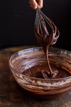 someone is whisking chocolate into a bowl