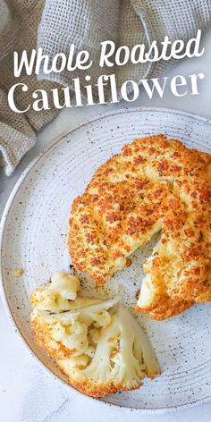 whole roasted cauliflower on a plate with the words whole roasted cauliflower