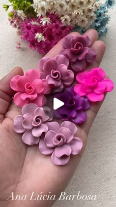 a person is holding some fake flowers in their hand