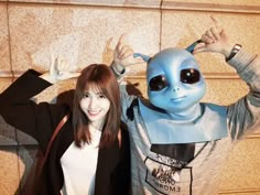 two people dressed up as aliens posing for the camera