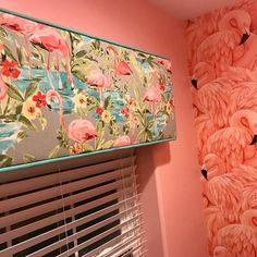 pink flamingos are painted on the wall next to a window with blind shades and blinds