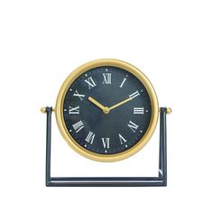 a black and gold clock with roman numerals sitting on a metal stand against a white background