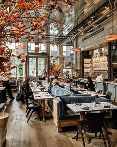 the interior of a restaurant with many tables and chairs