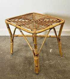 a table made out of bamboo sticks on the floor