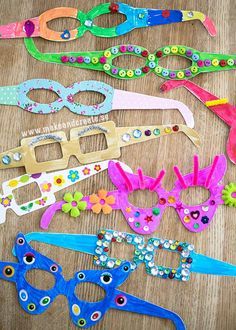 several pairs of eyeglasses made to look like flowers and butterflies are sitting on a table