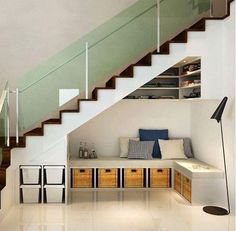 a room with some drawers under the stairs