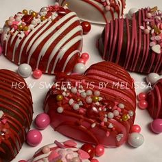 red and white heart shaped cakes with candy toppings on them are arranged in the shape of hearts